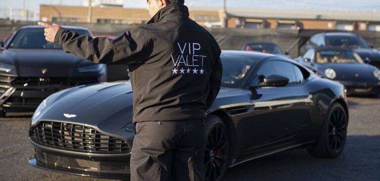 VIP valet pointing in one direction to steer