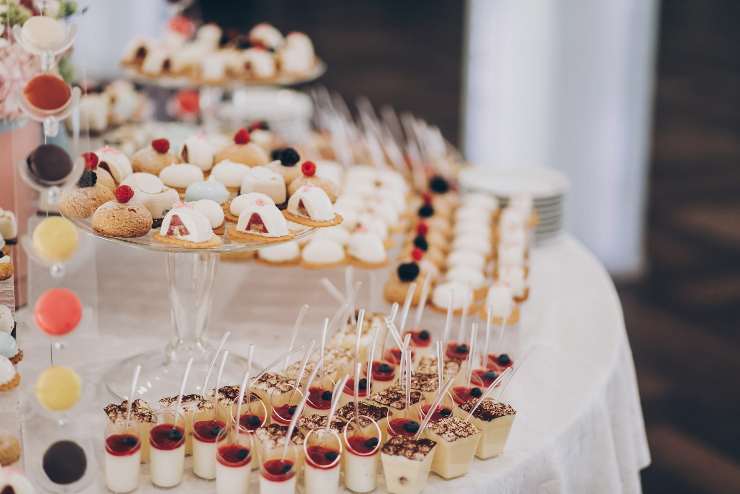 Wedding candy bar Delicious creamy desserts with fruits, panna cotta, cakes and cookies